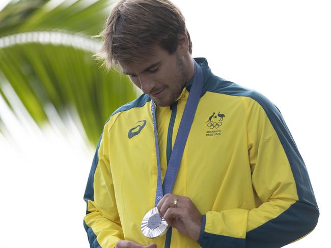 TEAHUPO'O, FRENCH POLYNESIA - AUGUST 05: Silver Medalist Jack Robinson of Team Australia looks at his medal on the podium during the Men's surfing medal ceremony on day nine of the Olympic Games Paris 2024 on August 05, 2024 in Teahupo'o, French Polynesia. (Photo by Sean M. Haffey/Getty Images)