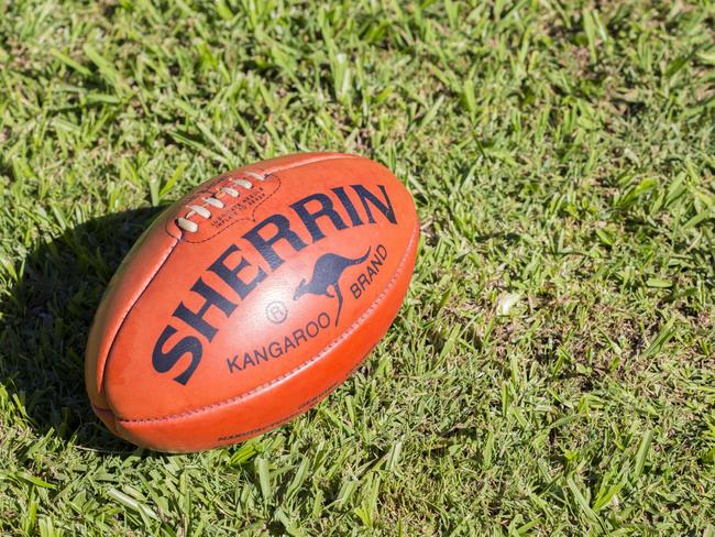 "Lismore, NSW, Australia - May 9, 2012: A Kangaroo Brand Sherrin football sits on grass. This is the official ball of AFL, Australian Rules Football, and has been used since the 1880s"