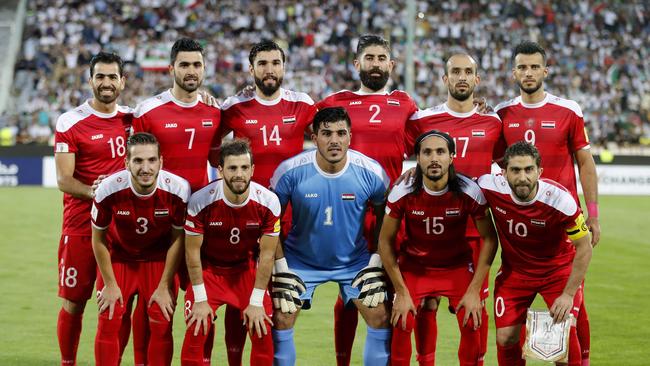 Syrian players pose prior to the FIFA World Cup 2018 qualification football match between Syria and Iran at the Azadi Stadium in Tehran on September 5, 2017.