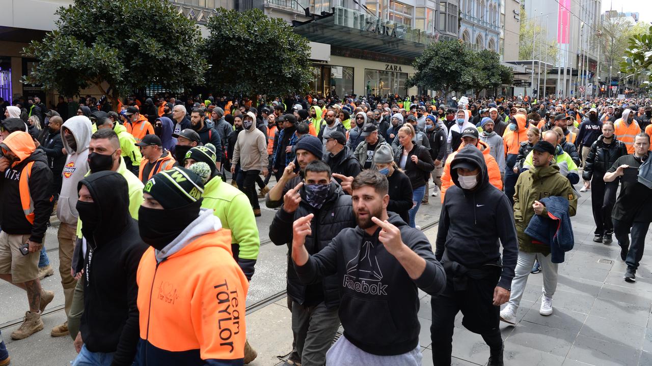 Protesters walk through central Melbourne after yesterday's violent protests outside the CFMEU against mandatory vaccinations for workers on building sites. Picture: Andrew Henshaw