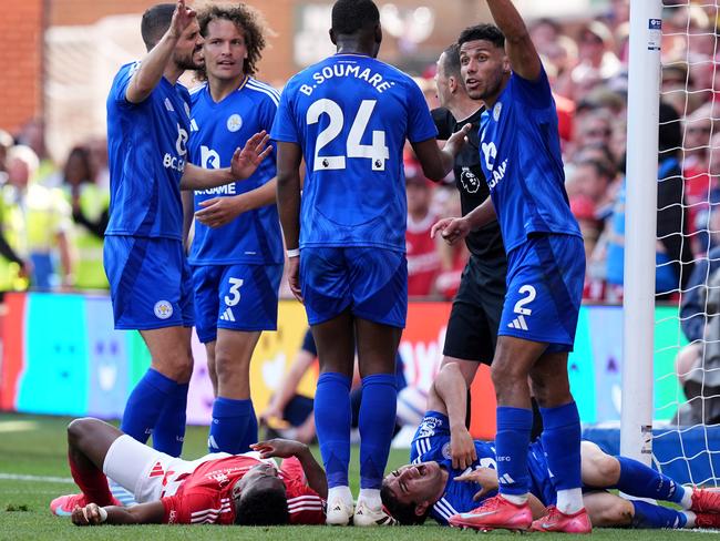 Nottingham Forest's Taiwo Awoniyi and Leicester City's Facundo Buonanotte (on the ground, right) after colliding with the goalpost. Picture: Jacob King/PA Images via Getty Images