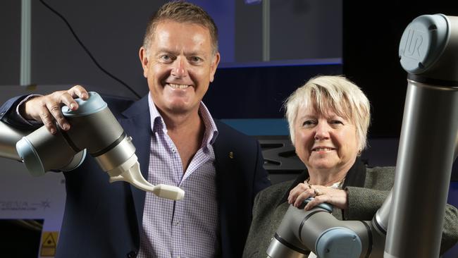 Flinders Uni Vice-Chancellor Professor Colin Stirling and BAE Systems Director Sharon Wilson with robotic arms in the Flinders University digital testing and trial collaboration hub at Tonsley Innovation District, Tonsley. Photographer: Emma Brasier