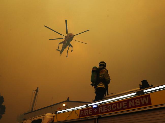 Firefighters on the ground look to the air for reinforcements. Picture: Sam Ruttyn