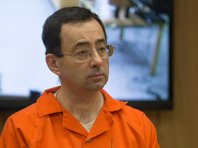 (FILES) In this file photo taken on February 5, 2018 former Michigan State University and USA Gymnastics doctor Larry Nassar appears in court for his final sentencing phase in Eaton County Circuit Court in Charlotte, Michigan. - American lawmakers made 15 recommendations to the US Olympic Committee on December 20, 2018 to better safeguard athletes from sexual abuse in the wake of the Larry Nassar gymnastics scandal. Suggestions by the House of Representatives Energy and Commerce Committee in its 133-page report included more USOC punishment options for 48 national sport governing bodies and open talk about sexual abuse without non-disclosure deals. (Photo by RENA LAVERTY / AFP)