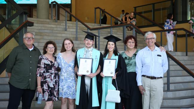 Graduates Brett Kornelissen (left) and Chantelle Porter-Dabrowski (right) both earned a Bachelor of Paramedic Science surrounded by family. The pair flew up to Cairns six times while doing their course online from Adelaide. Picture: Elodie Jakes