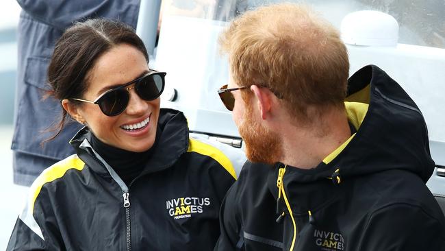 The Duchess of Sussex and Prince Harry chat at the Invictus Games sailing events on Sydney Harbour yesterday. Picture: Getty