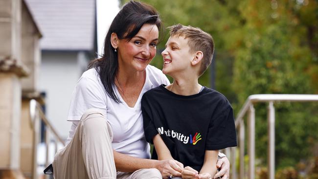 Jo O’Brien with her son Henry in Lewisham. Henry is non-verbal and uses tech on his phone to interact with his mum. Picture: Sam Ruttyn