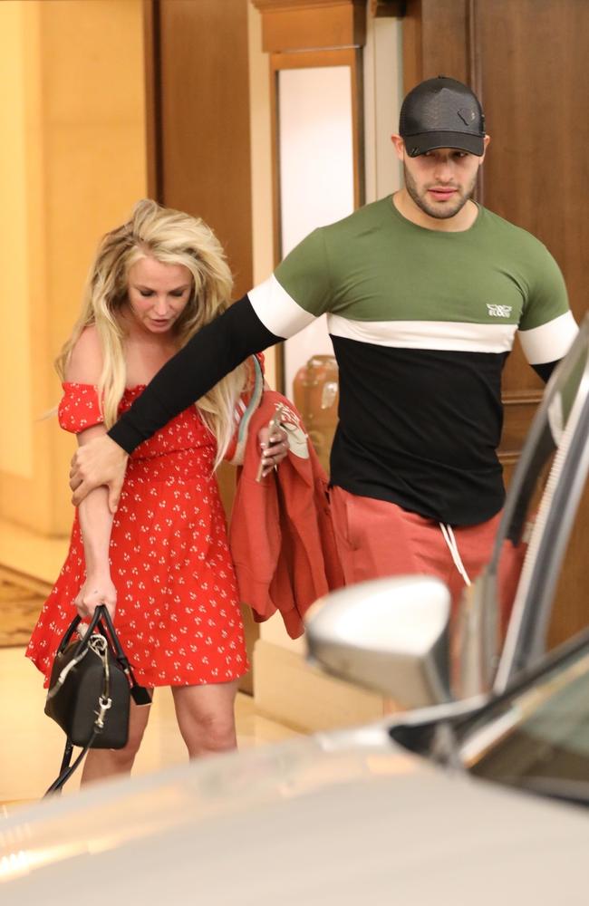 Boyfriend Sam Asghari protectively grips Britney’s arm. Picture: BACKGRID 