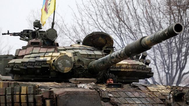 A serviceman from the Ukrainian Military Forces looks out from his tank in the Lugansk region. Picture: AFP