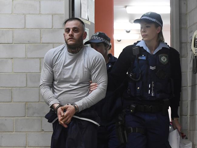 Yusuf Nazlioglu is escorted from Kogarah police station following his arrest in August, 2018. Picture: Gordon McComiskie