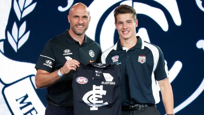 Carlton legend Chris Judd presented pick 19 Liam Stocker with a jumper after the Blues swooped on draft night. Pic: Getty Images