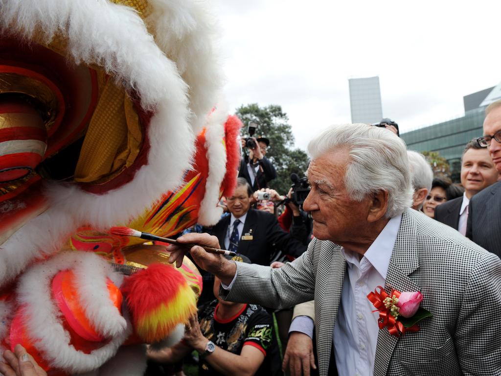Former Prime Minister Bob Hawke along with Foreign minister Bob Carr, takes part in celebrations marking the 40th anniversary of diplomatic relations between Australia and China, in Sydney. Pictured painting the eye of a Chinese dragon.