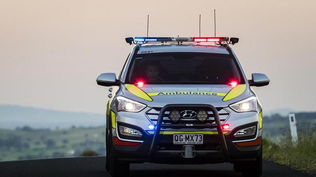 Paramedics treat a patient after a crash on Toowoomba-Athol Rd. 