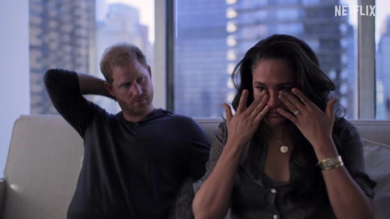 Meghan Markle wipes her eyes as a concerned Prince Harry looks on. Picture: Netflix