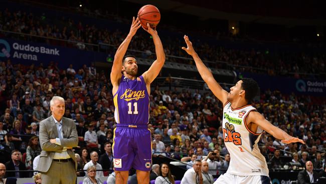 Sydney Kings’ Kevin Lisch shoots against Cairns Taipans as Kings coach Andrew Gaze looks on. Picture: AAP