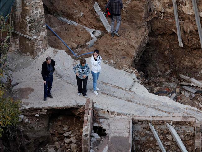 Devastated locals look at damaged road and houses following floods in Letur, southwest of Valencia. Picture: AFP