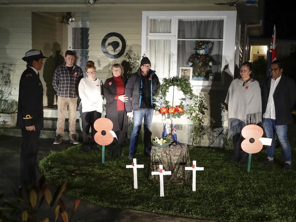 Neighbours gather at dawn to commemorate Anzac Day in a suburb of Christchurch, New Zealand. Picture: Mark Baker/AP