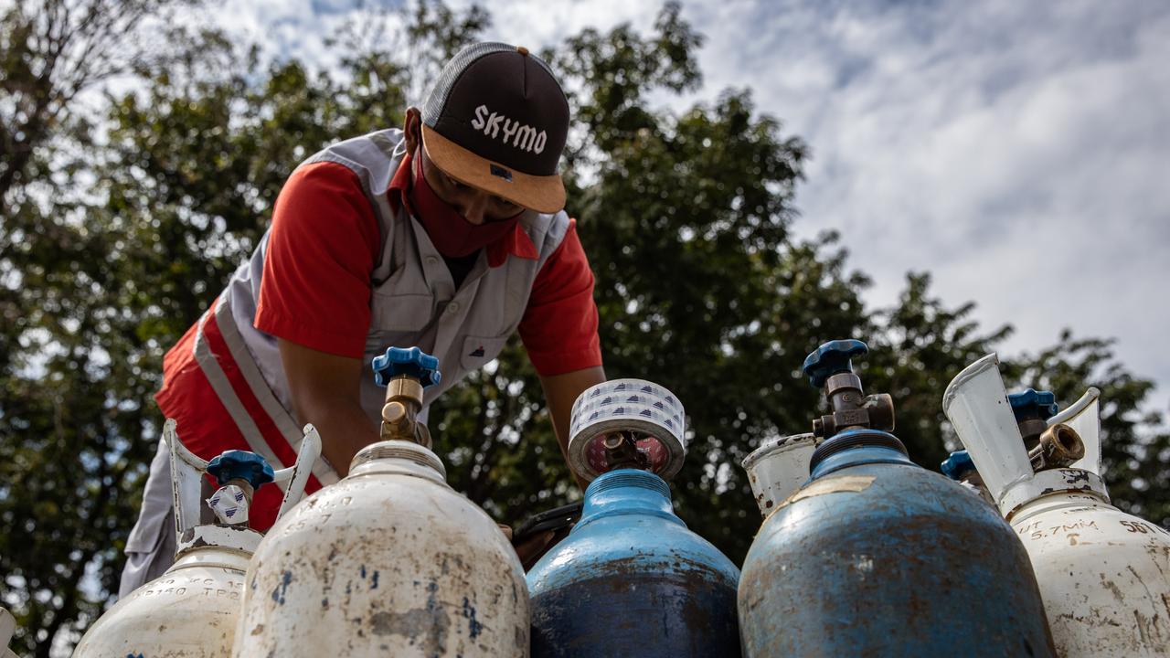 A worker prepares oxygen tubes for Covid-19 patients at Indrapura Emergency Field Hospital. Picture: Getty Images