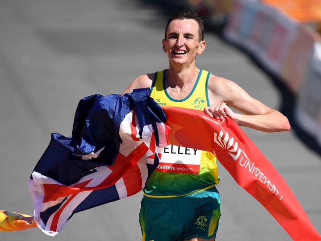 Michael Shelley of Australia crosses the finish line to win the Men's Marathon Final on day eleven of competition on the Gold Coast, Australia, Sunday, April 15, 2018. (AAP Image/Dean Lewins)