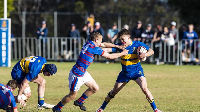 Tom McDonald (left) of Downlands tackles Will Holley of Grammar in O'Callaghan Cup on Grammar Downlands Day at Downlands College, Saturday, August 6, 2022. Picture: Kevin Farmer