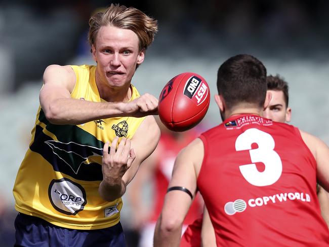 Jack Lukosius handballs over Keenan Ramsey. Picture: SARAH REED