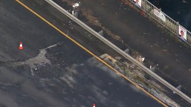 Hydrochloric acid has dissolved part of a busy Sydney road after chemical drums fell off a truck on Thursday. Picture: 9 News