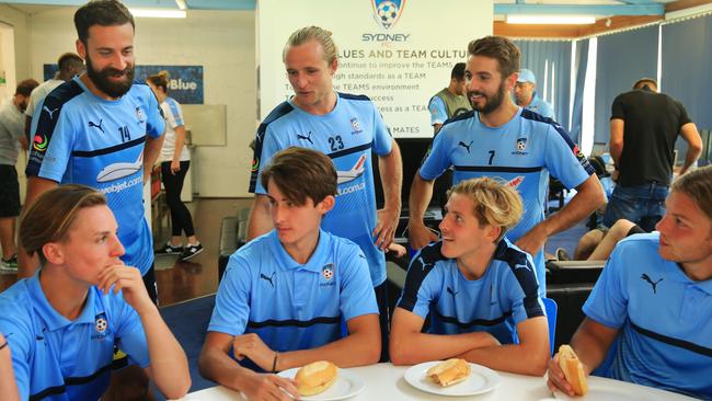 Sydney FC players (l-r) Alex Brosque, Rhyan Grant and Michael Zullo mix with members of the under-18 squad as part of a bonding session after training at Macquarie Park.