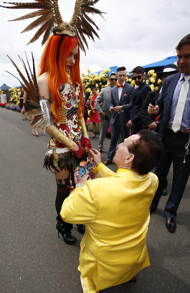 Geoffrey Edelsten proposing to his girlfriend, Gabi Grecko at the Melbourne Cup. Picture: Bradley Hunter