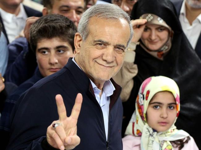 Iranian reformist presidential candidate Masoud Pezeshkian at a polling station Friday, flashing a victory sign. Picture: Stringer/Shutterstock/WSJ