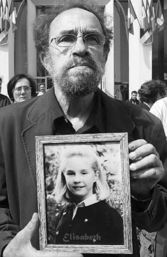 Elisabeth Brichet’s father, Francis Brichet, holds a photo of her outside court. Picture: Reuters