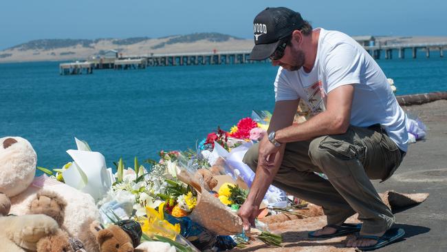 The brother of Damien Little, Shannon Little, visits the growing memorial site at Port Lincoln’s main wharf. Picture: Ivon Perrin