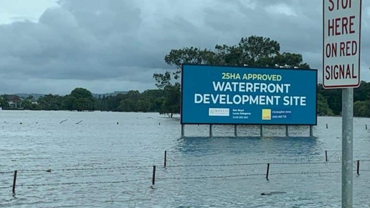 A sign for a Gold Coast commercial development has been mocked for its 'waterfront' views after the site was inundated by floodwaters. Picture: Reddit