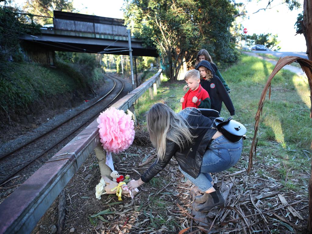 People lay flowers at the scene where Lily was killed. Picture Rebecca Michael