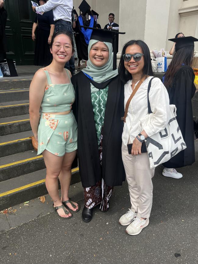 Yiyi Yeap, Niemas Bumi (Master of Social Policy) and Lilik at the University of Melbourne graduations held at the Royal Exhibition Building on Monday, December 16, 2024. Picture: Jack Colantuono