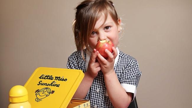 Sunshine prep student London Collins helps pack her school lunch box. Picture: Ian Currie