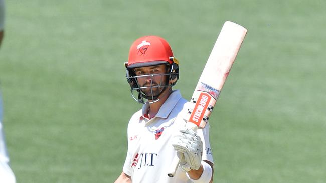 South Australia’s Callum Ferguson raises his bat after reaching a half-century during day 4 of the Round 7 Sheffield Shield cricket match between South Australia and Tasmania at Adelaide Oval. Picture: AAP/David Mariuz.