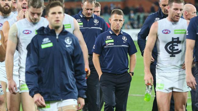 ADELAIDE, AUSTRALIA — APRIL 21: Blues head coach Brendon Bolton looks dejected as Marc Murphy of the Blues leads the team off after defeat during the round five AFL match between the Port Adelaide Power and thew Carlton Blues at Adelaide Oval on April 21, 2017 in Adelaide, Australia. (Photo by Michael Dodge/Getty Images)