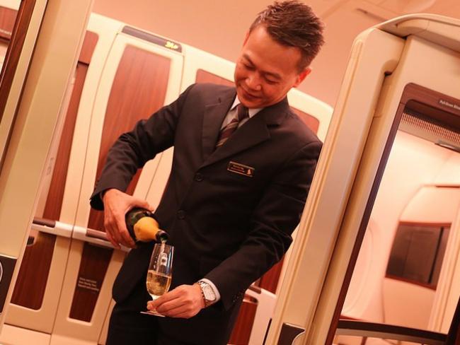 Daniel enjoyed the free flowing Champagne on board his Singapore Airlines First Class flight. Picture: Dan Gillaspia/Upon Arriving