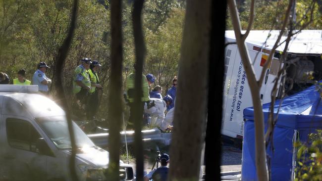 Emergency crews working to remove bodies at the scene. Picture: Jonathan Ng