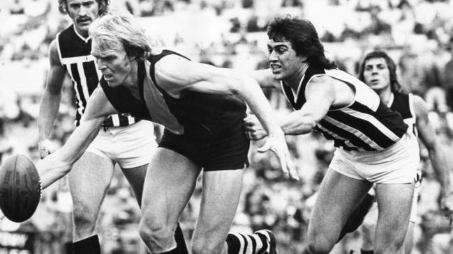 Graham Cornes and Andy Porplycia compete in a match between Glenelg and Port Adelaide in 1976. Picture: Bryan Charlton