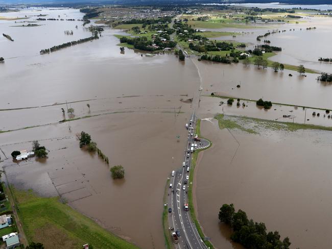 NSW Rescue workers searching for two people swept away in a car from the causeway on Cessnock Road, Maitland today. Picture: Adam Taylor