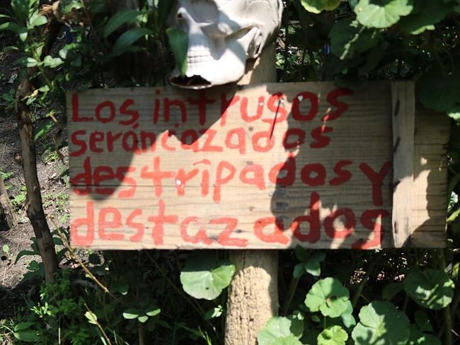 Sign at the entrance to Isla de las Munecas, Xochimico, Mexico, indicates trespassers will be hunted down and butchered. Picture: Wikimedia Commons/Emy Pheebs