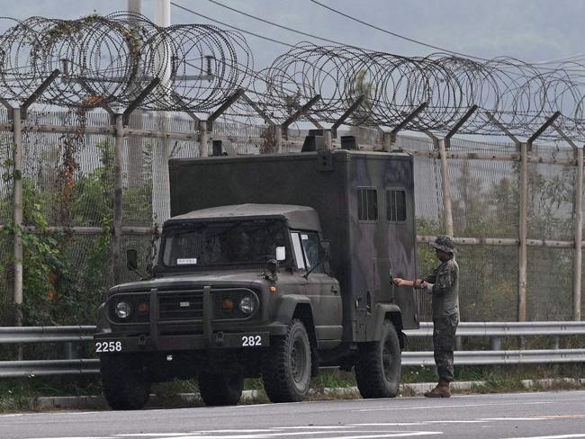 A South Korean soldier checks a military vehicle near a military checkpoint on the Tongil bridge, the road leading to North Korea's Kaesong city.