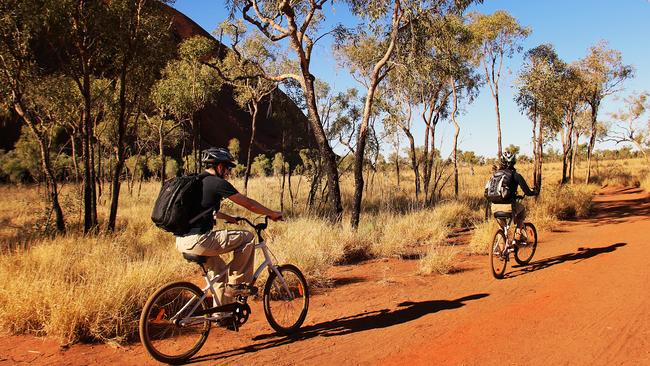 Cycling around Uluru. Picture: Sarena Hyland/Tourism NT