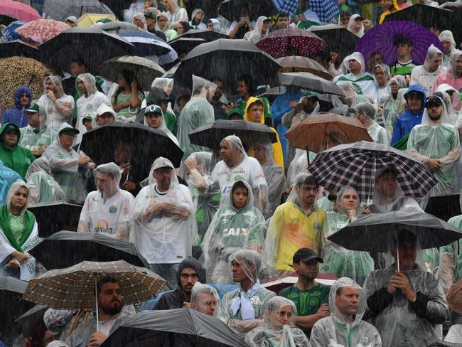 Mourners await for the arrival of the cortege with the coffins of the members of Chapecoense Real. Picture: AFP/Nelson Almeida