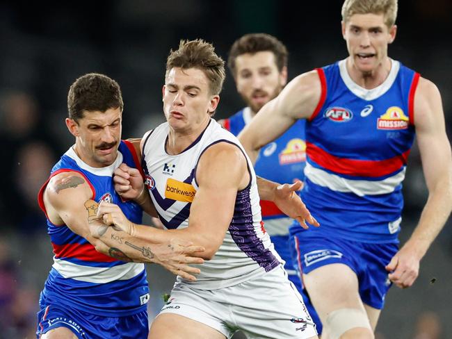 MELBOURNE, AUSTRALIA - JUNE 15: Tom Liberatore of the Bulldogs and Caleb Serong of the Dockers compete for the ball during the 2024 AFL Round 14 match between the Western Bulldogs and the Fremantle Dockers at Marvel Stadium on June 15, 2024 in Melbourne, Australia. (Photo by Dylan Burns/AFL Photos via Getty Images)