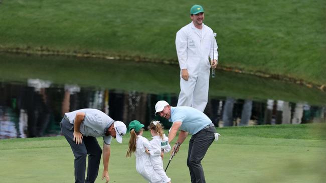Rory McIlroy celebrates a putt by his daughter, Poppy, alongside Shane Lowry of Ireland on the ninth green. Widely regarded as one of the best players of his generation, McIlroy’s breakthrough came in 2011 when he won the U.S. Open by an impressive 8-stroke margin, becoming the youngest player to win the tournament since 1923. Picture: AFP