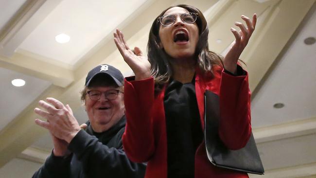 Alexandria Ocasio-Cortez, with Michael Moore at a rally for Bernie Sanders in Iowa City, Iowa. Picture: AP.