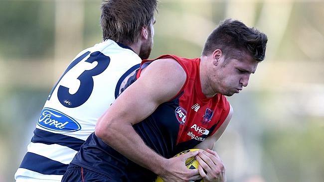 Hogan marks in front of Tom Lonergan in NAB Challenge clash. Picture Wayne Ludbey. 