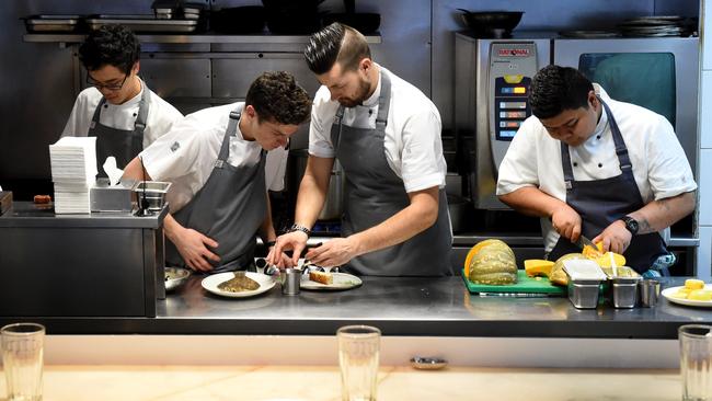 The Cumulus Inc chefs behind the kitchen bar.